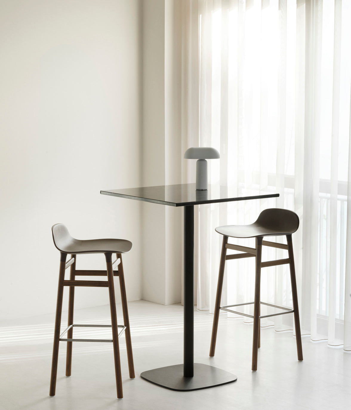 A square cafe table forms wooden top with a black base