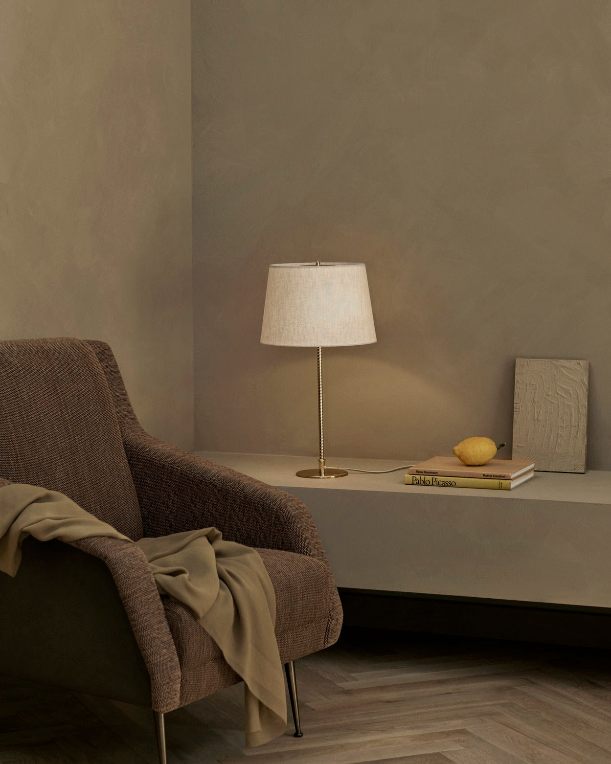 CDC.1 upholstered armchair with a brass base