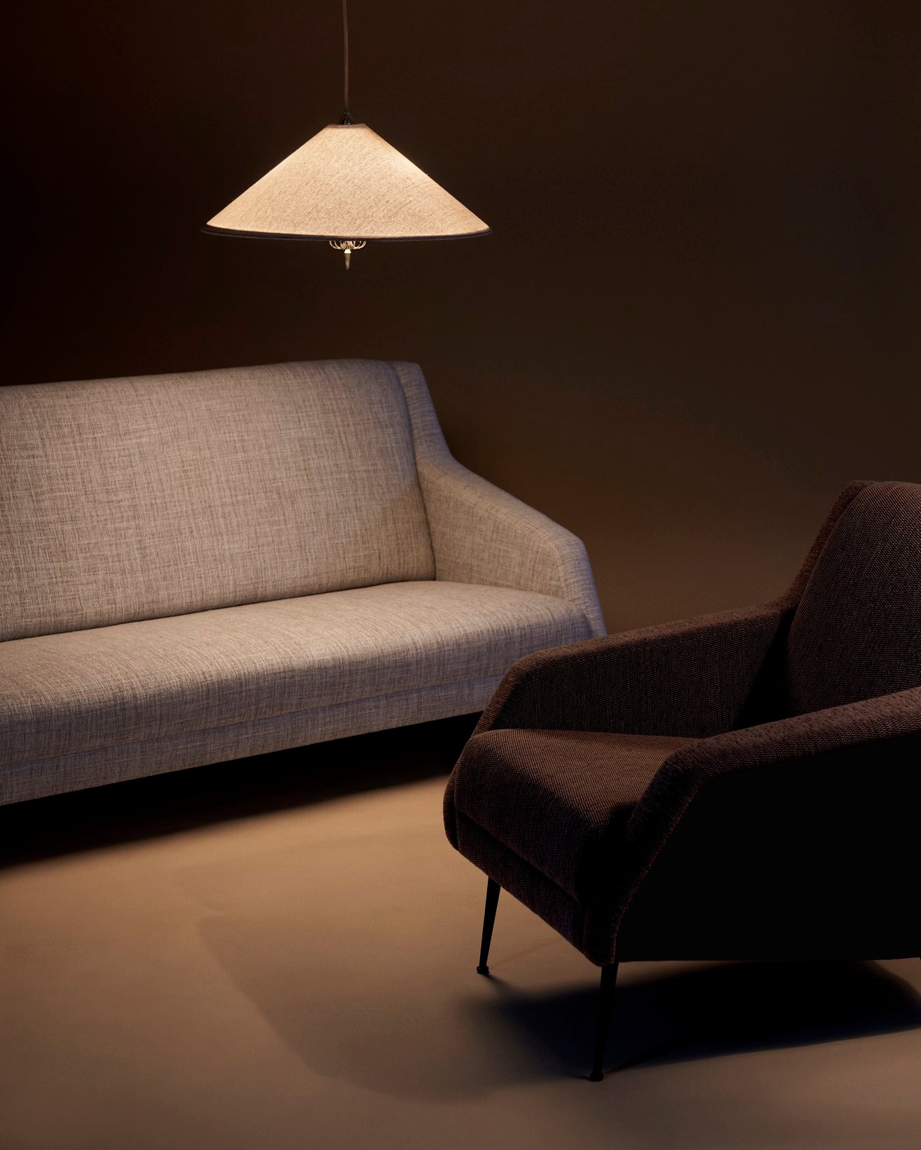 CDC.1 upholstered armchair with a brass base