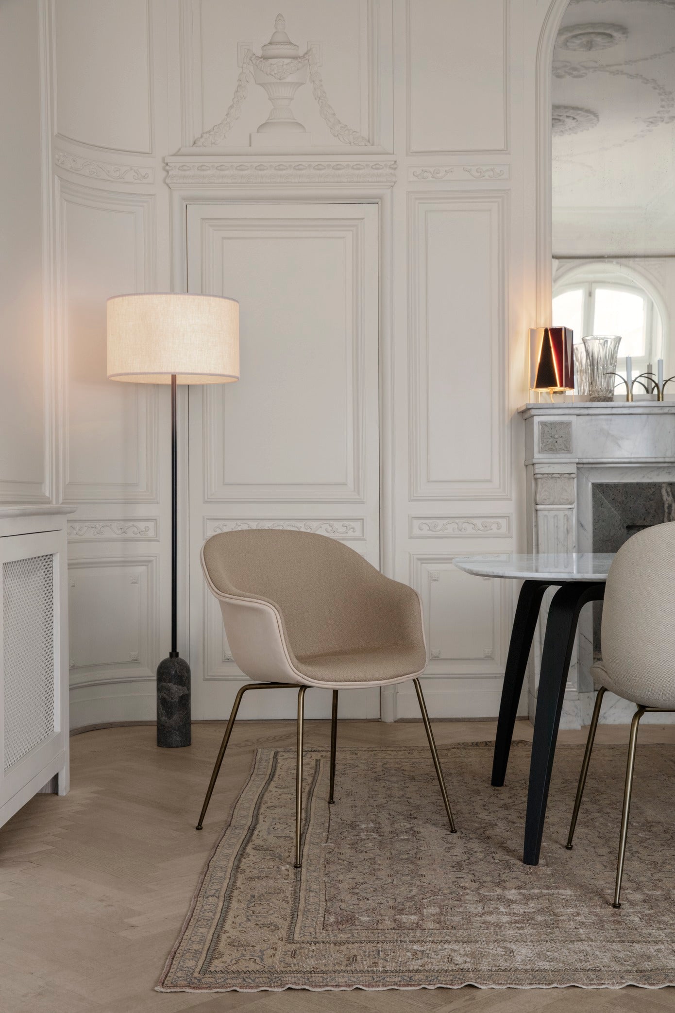 Upholstered BAT chair with a brass base