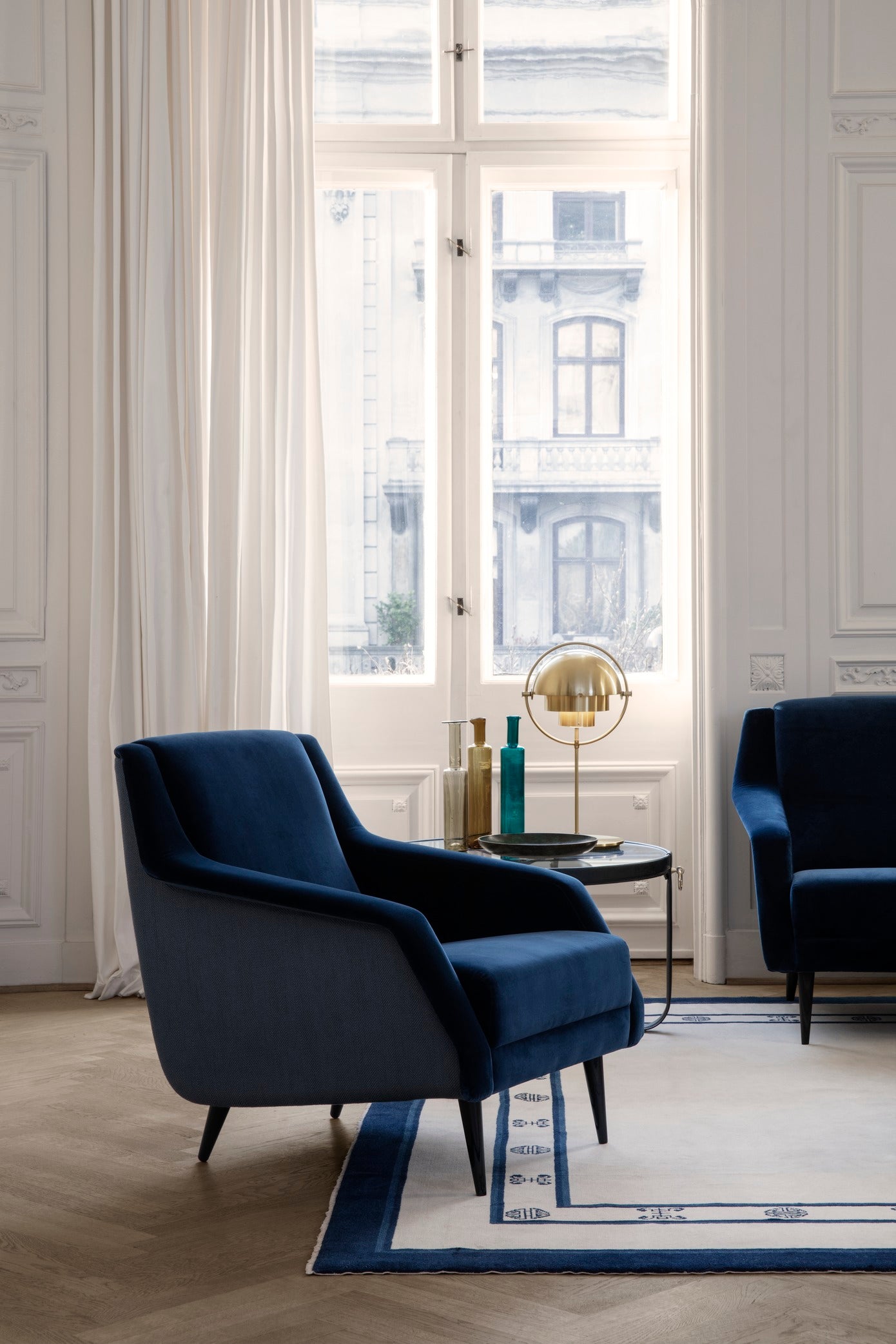 CDC.1 upholstered armchair with a brass base
