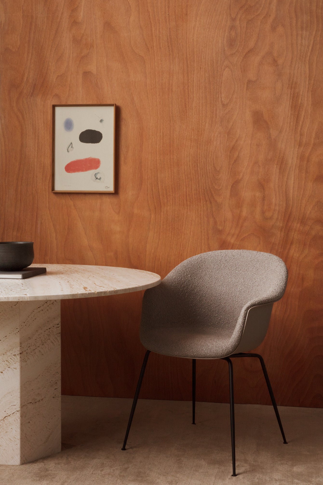 Upholstered BAT chair with a brass base