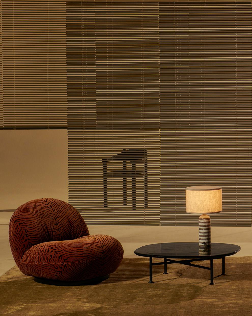PACHA upholstered armchair with a black base