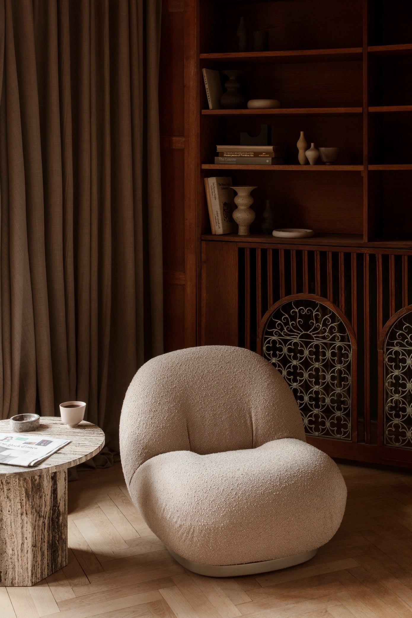 PACHA upholstered armchair with a black base