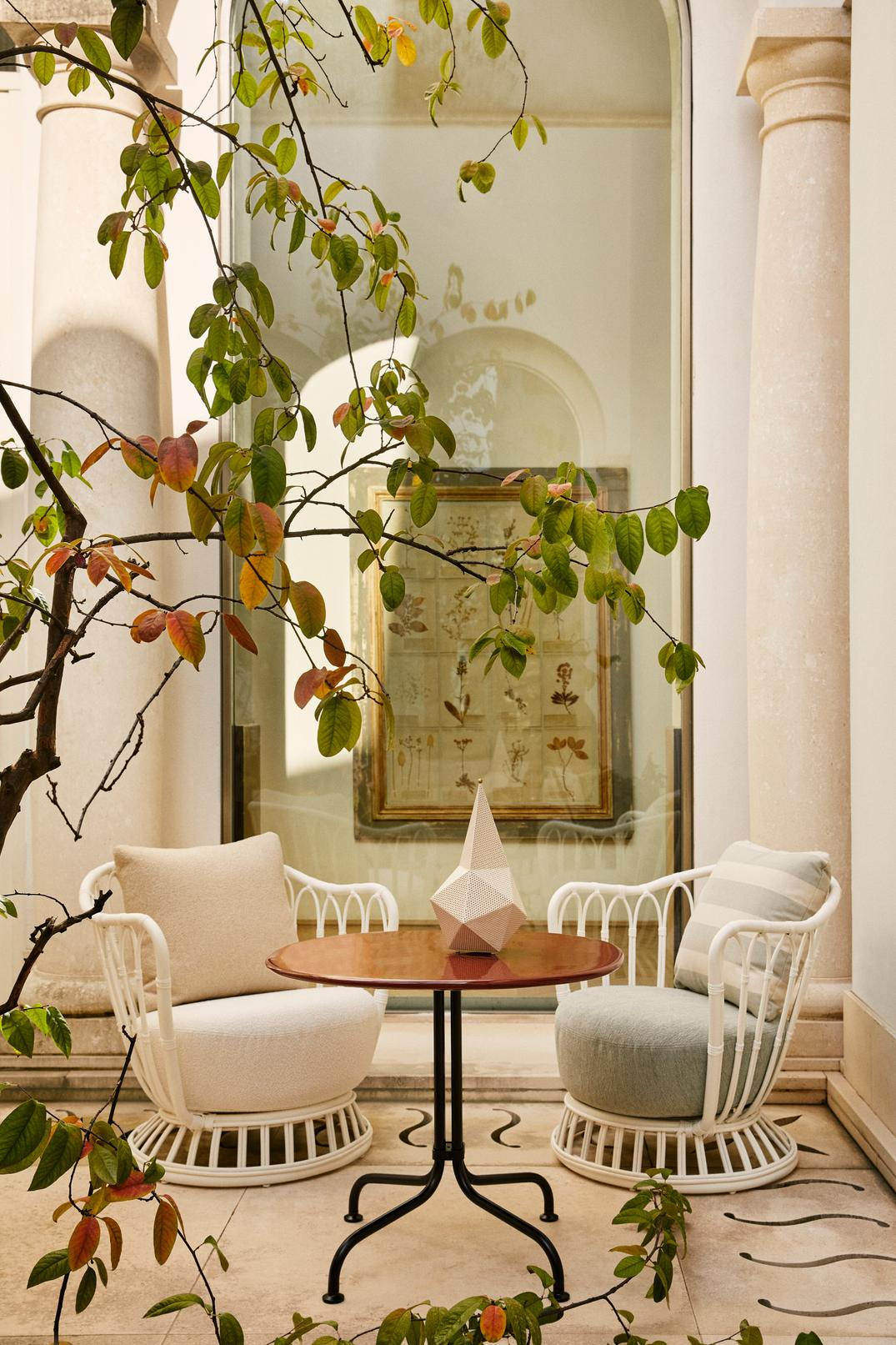 GRACE upholstered garden armchair with a black base