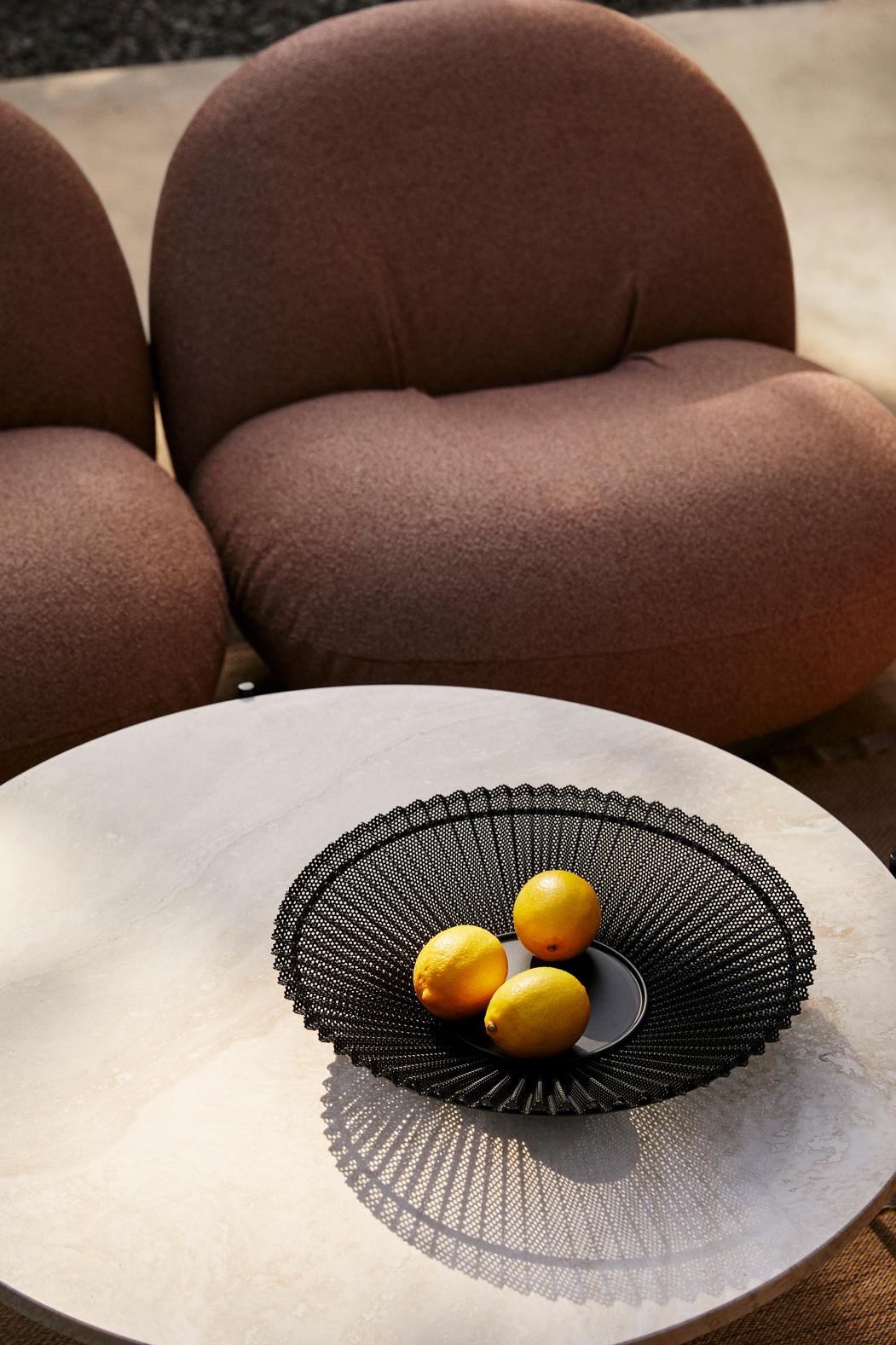 PACHA upholstered armchair with a black base