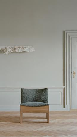 Tenon upholstered armchair with an oak base