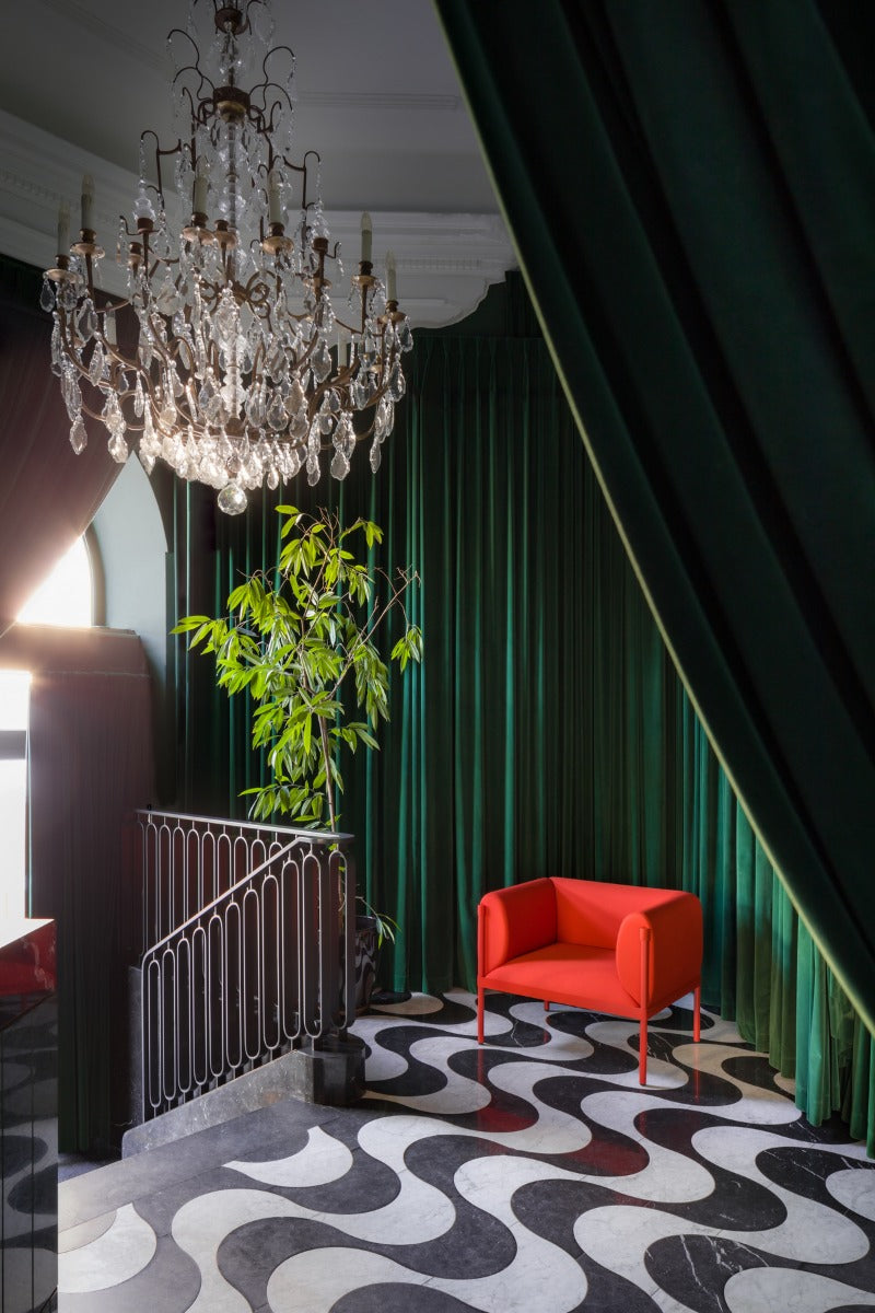 Low upholstered stilt armchair
