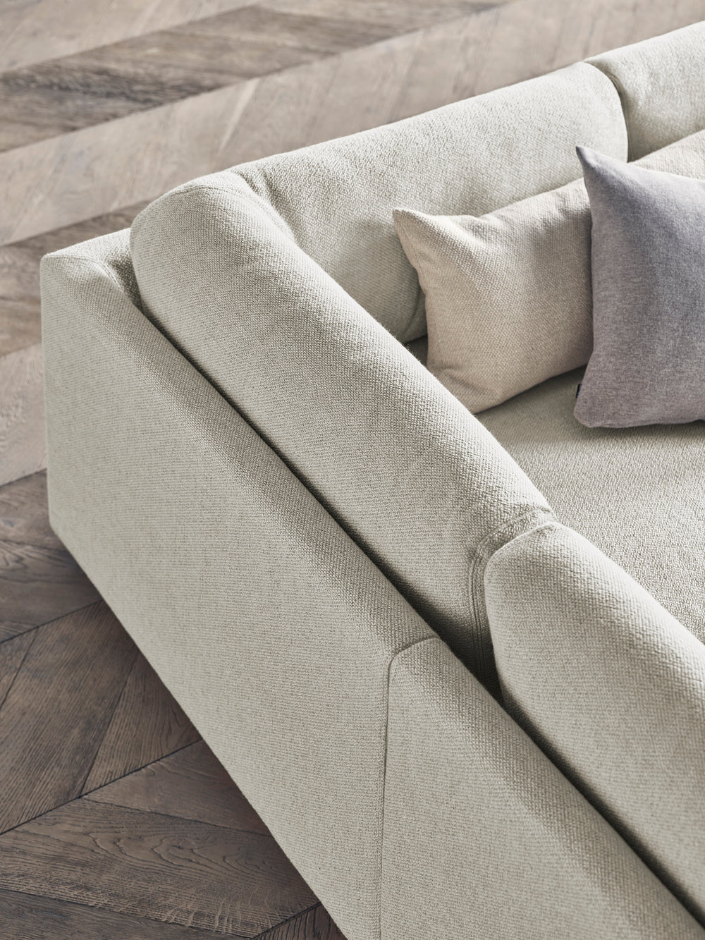 A corner with a left -hand sepia chaise with an oak base