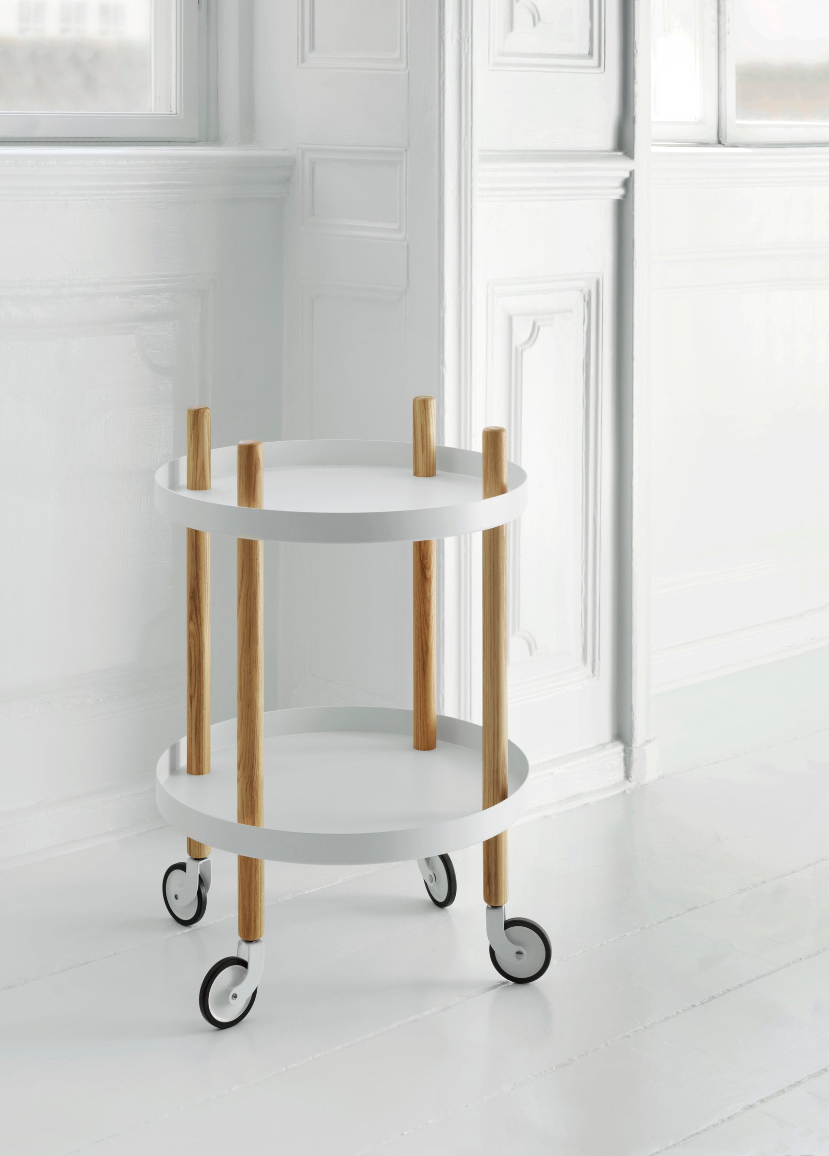 A wheelchair on wheels, round white block with ash legs
