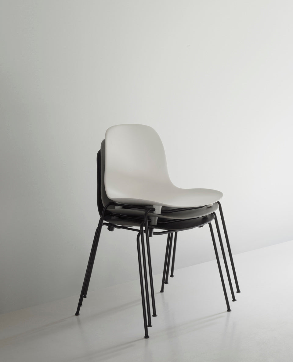 A chair of forms of green stacking with a black base