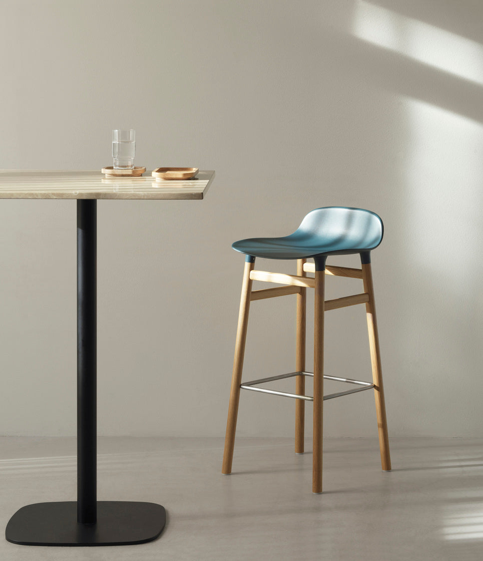 Hocker bildet warmes Grau mit einer Eichenbasis