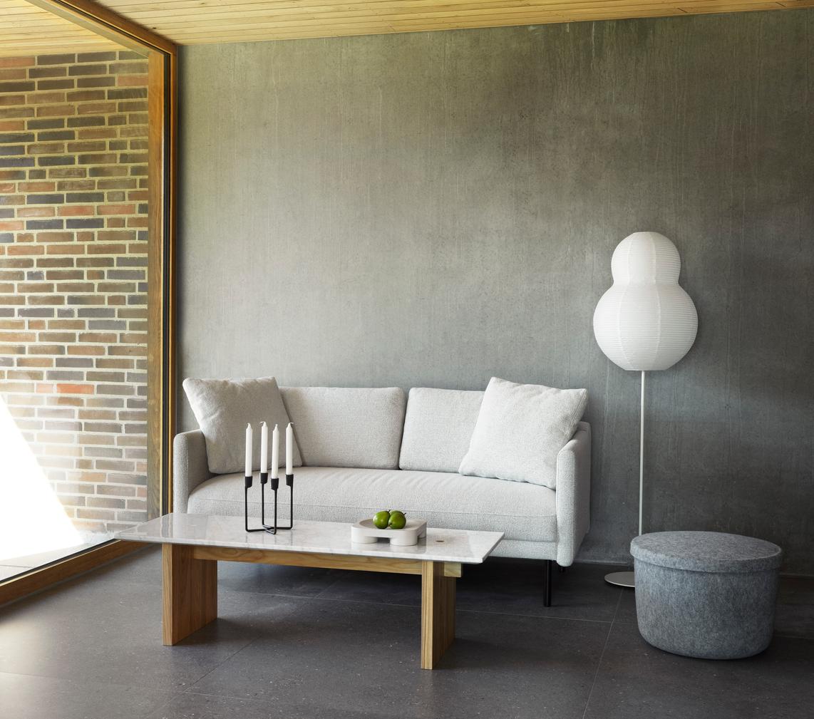 Light gray rar sofa with a black base