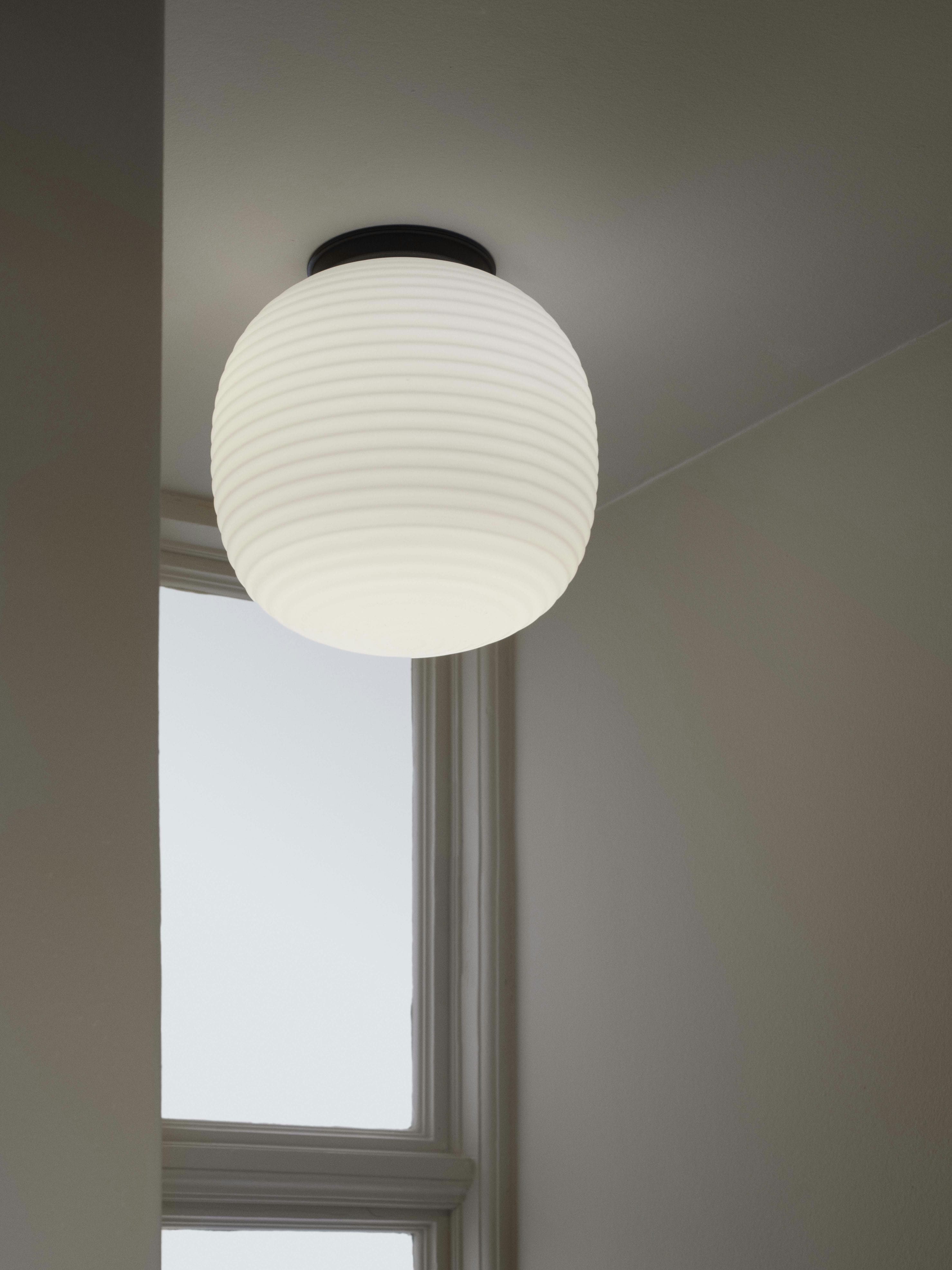 Lantern white ceiling lamp with a black base