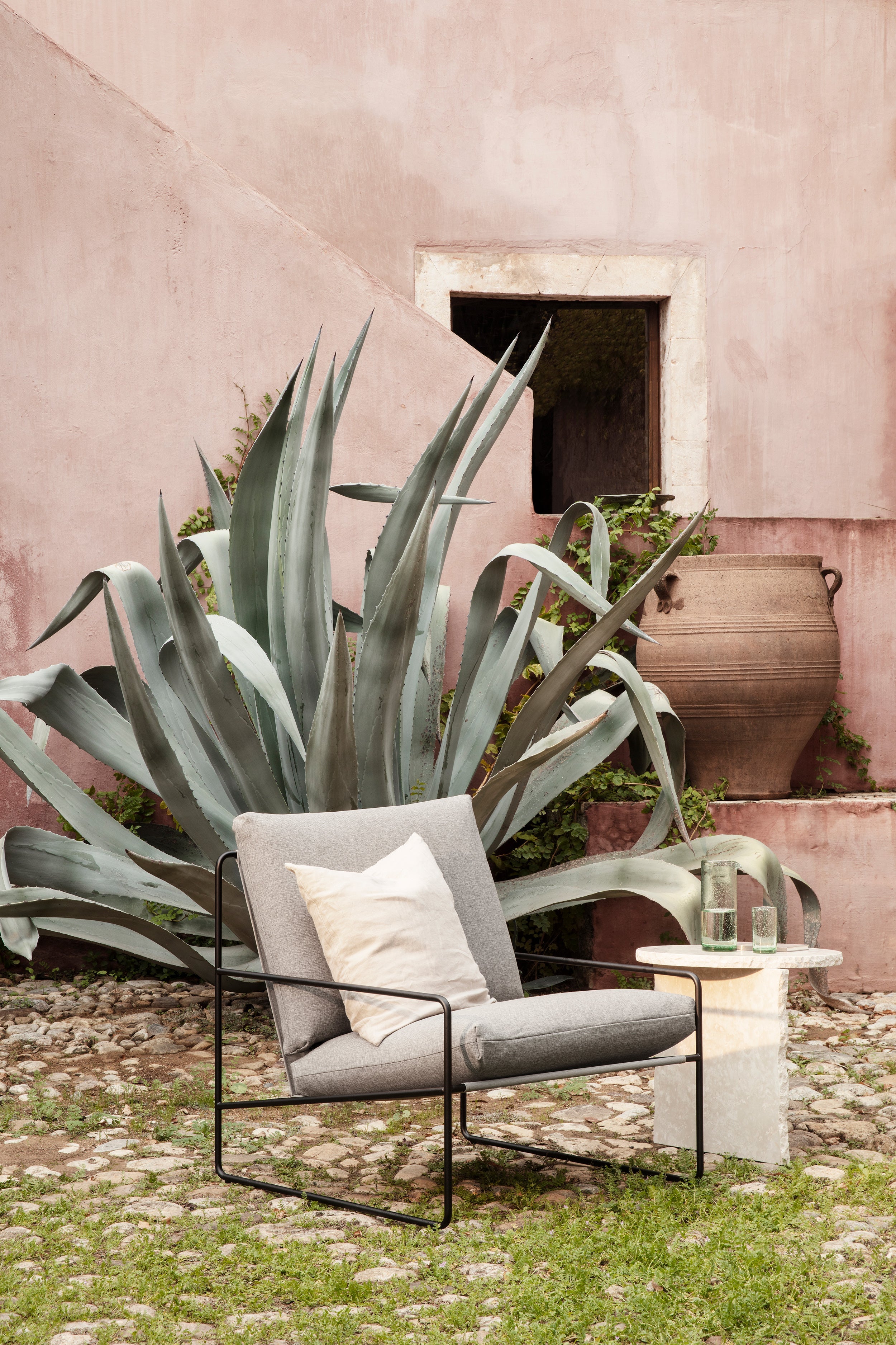 Desert beige external armchair with a black base