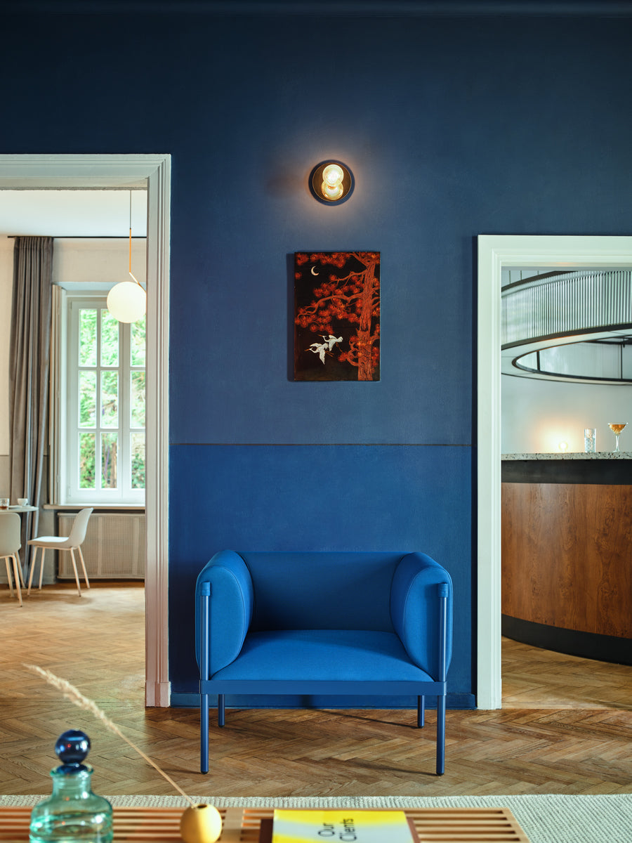 Low upholstered stilt armchair