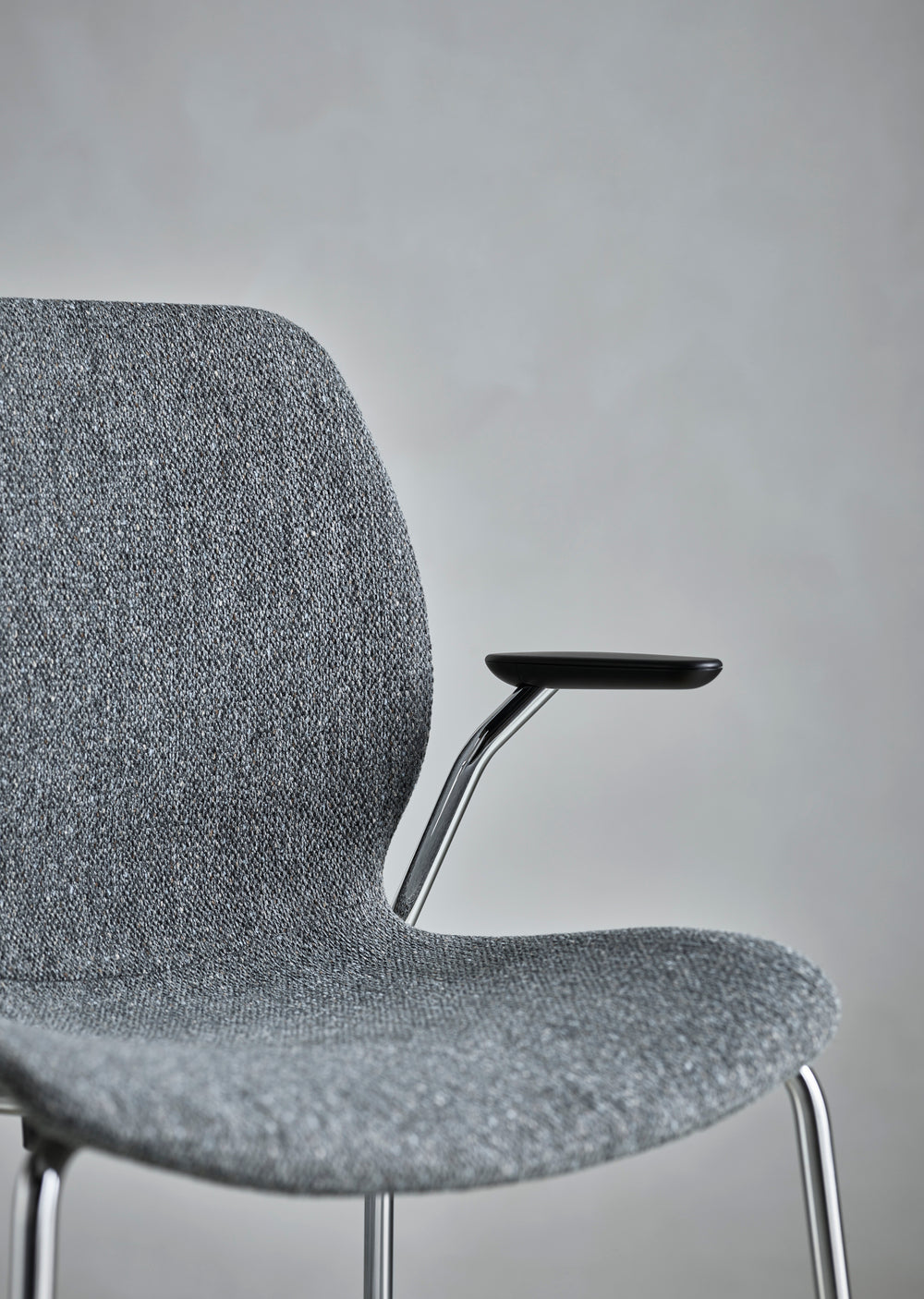 Seed chair upholstered with a gray base